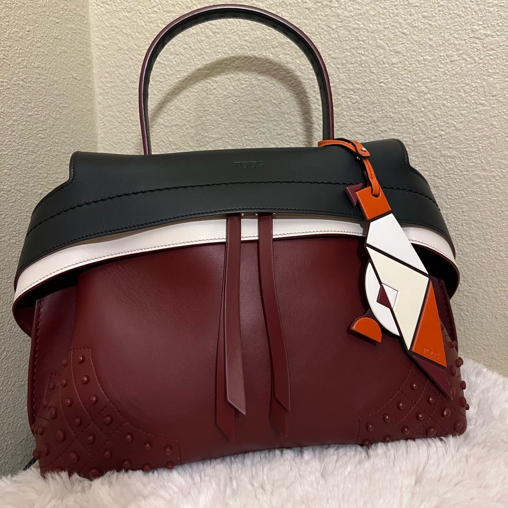 Tod's limited edition hand bag w long crossbody stripe and a limit edition charm